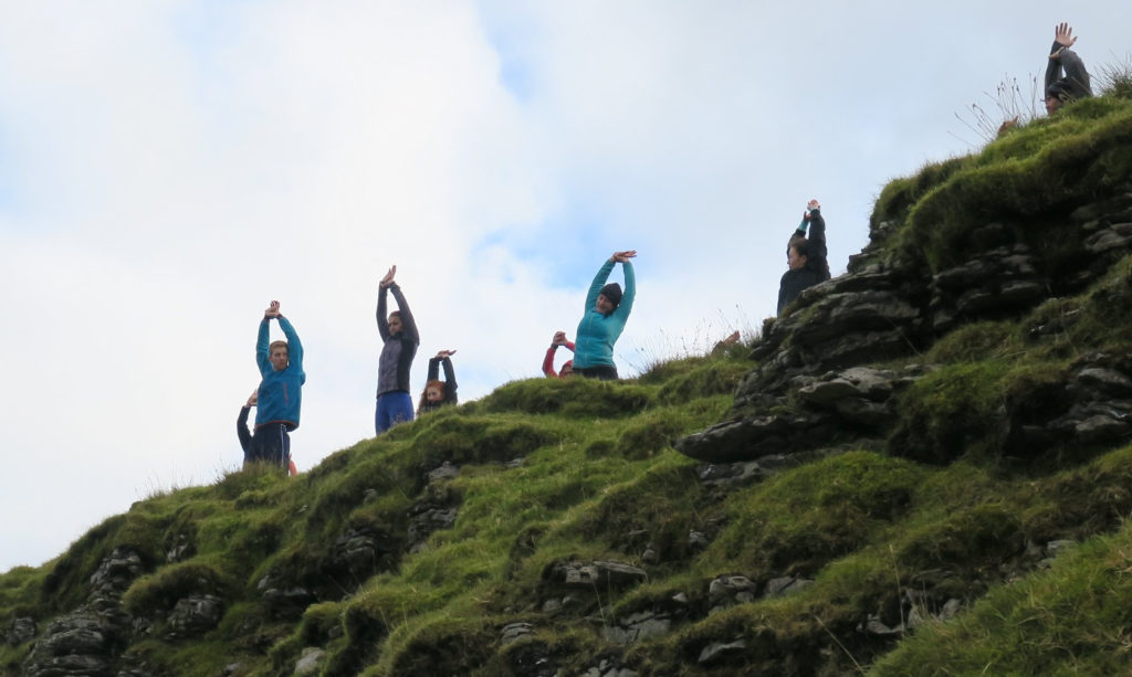 People exercising on the top of the mountain