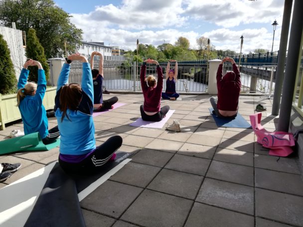 People sitting on mats doing yoga