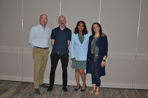 Four people posing to photography